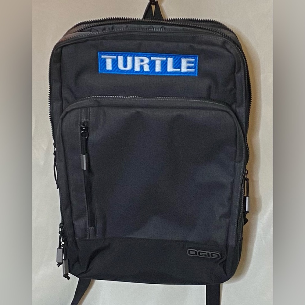 OGIO Sly 15" Laptop Backpack in gray/black with a custom "TURTLE" patch